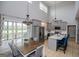 Bright kitchen with island, table and chairs, stainless appliances, and outside access at 1074 Glenloch Rd, Roopville, GA 30170