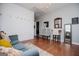 Living room with wood floors, decorative wall, and comfortable blue couch at 1074 Glenloch Rd, Roopville, GA 30170