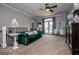 Comfortable loft living room area features a plush green sofa, and a door to the outside at 1074 Glenloch Rd, Roopville, GA 30170