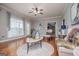 Cozy living room with hardwood floors, plush seating, and natural light streaming through windows at 1074 Glenloch Rd, Roopville, GA 30170