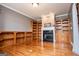 Spacious living room featuring a fireplace, built-in shelving, and hardwood floors at 1074 Glenloch Rd, Roopville, GA 30170
