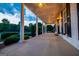 Beautiful white porch with large columns, lighting and ceiling fans overlooks a well-manicured lawn at 1074 Glenloch Rd, Roopville, GA 30170