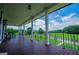 Inviting covered porch with railing showcasing picturesque views and outdoor seating at 1074 Glenloch Rd, Roopville, GA 30170