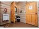 The commercial bathroom features a urinal, sink, trashcan and wood door at 1074 Glenloch Rd, Roopville, GA 30170