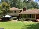 Expansive backyard with a well-maintained lawn and mature trees, offering privacy at 3746 Gladney Dr, Atlanta, GA 30341