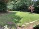 Lush backyard with a well-maintained lawn, stepping stones, and plenty of greenery at 3746 Gladney Dr, Atlanta, GA 30341