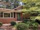 Charming brick home with large windows, black shutters and well-maintained landscaping at 3746 Gladney Dr, Atlanta, GA 30341