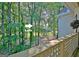 Private balcony offering glimpses of the lake through a lush, green forest at 504 Ridgelake Dr, Peachtree City, GA 30269