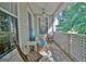 Breezy covered balcony with wicker furniture and a ceiling fan, perfect for enjoying the scenery at 504 Ridgelake Dr, Peachtree City, GA 30269