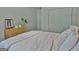 Bedroom with a wooden bed frame, neutral bedding, and light green walls at 504 Ridgelake Dr, Peachtree City, GA 30269