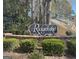 Welcome to Ridgelake, as shown by the beautifully landscaped entrance sign amidst lush greenery at 504 Ridgelake Dr, Peachtree City, GA 30269