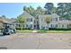 Apartment complex with nice lawns, mature trees, and condo entrances in the front at 504 Ridgelake Dr, Peachtree City, GA 30269