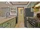 Modern kitchen boasts stone countertops, stainless steel appliances, and custom cabinetry at 504 Ridgelake Dr, Peachtree City, GA 30269