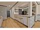 Partial view of kitchen with green cabinets, bar seating and dark door at 504 Ridgelake Dr, Peachtree City, GA 30269