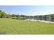 View of the lake from the yard with green grass at 504 Ridgelake Dr, Peachtree City, GA 30269