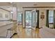 An open-concept living room boasts wood floors and access to an outdoor balcony at 504 Ridgelake Dr, Peachtree City, GA 30269