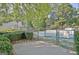 Fenced in tennis court featuring landscaping and shaded surroundings at 504 Ridgelake Dr, Peachtree City, GA 30269