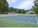 Tennis court featuring landscaping, shade trees, and a building in the background at 504 Ridgelake Dr, Peachtree City, GA 30269