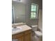 Standard bathroom featuring a single sink, toilet, and window providing natural light at 645 Stadler Pointe, Mcdonough, GA 30253