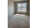 Neutral bedroom with carpet flooring, neutral paint, and large window for natural light at 645 Stadler Pointe, Mcdonough, GA 30253