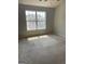 A bright bedroom with carpeted flooring and a large window with outside views at 645 Stadler Pointe, Mcdonough, GA 30253