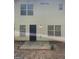 Back exterior of home showing the door, windows, and small patio at 645 Stadler Pointe, Mcdonough, GA 30253