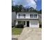 Two-story home with a well-maintained lawn, a garage, and classic black shutters at 645 Stadler Pointe, Mcdonough, GA 30253
