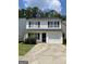 Charming two-story home with a garage, well-manicured lawn, and black shutters at 645 Stadler Pointe, Mcdonough, GA 30253