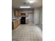 Spacious kitchen with laminate counters, oak cabinets, black appliances, and tile flooring at 645 Stadler Pointe, Mcdonough, GA 30253