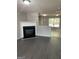 Bright living room featuring a fireplace, gray laminate floors, and plenty of natural light at 645 Stadler Pointe, Mcdonough, GA 30253