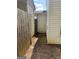 Narrow side yard between homes, showing a fence, exterior door, and utility access at 645 Stadler Pointe, Mcdonough, GA 30253
