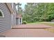 This backyard features a spacious deck, perfect for entertaining and enjoying the serene green surroundings at 85 Holly Springs Rd, Sharpsburg, GA 30277