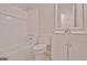 Bathroom with a toilet, bathtub/shower combo, and vanity with clean white finishes at 85 Holly Springs Rd, Sharpsburg, GA 30277