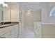 Bright bathroom boasts a white vanity with solid surface countertop and soaking tub with half-moon window at 85 Holly Springs Rd, Sharpsburg, GA 30277
