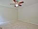 Empty carpeted bedroom features a lighted ceiling fan and neutral paint, waiting for personalization at 85 Holly Springs Rd, Sharpsburg, GA 30277