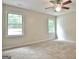 Bedroom with neutral paint, updated ceiling fan, carpet and windows at 85 Holly Springs Rd, Sharpsburg, GA 30277