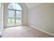 Empty bedroom features a large arched window providing a view of the outdoors and a bright interior at 85 Holly Springs Rd, Sharpsburg, GA 30277