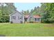 Charming one-story home featuring gray siding, black shutters, and a well-maintained front yard at 85 Holly Springs Rd, Sharpsburg, GA 30277