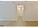 Hallway view of hardwood style floors, neutral paint and updated light fixtures at 85 Holly Springs Rd, Sharpsburg, GA 30277