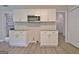 Kitchen features white cabinets, stainless steel microwave, granite counters and hardwood style floors at 85 Holly Springs Rd, Sharpsburg, GA 30277