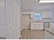 View of kitchen with white cabinets, granite counters and stainless steel appliances and hardwood style floors at 85 Holly Springs Rd, Sharpsburg, GA 30277