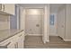 View of the white cabinets, granite counters, hardwood style floors and door to outside at 85 Holly Springs Rd, Sharpsburg, GA 30277