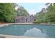The backyard features a pool and deck combination adjacent to the house at 85 Holly Springs Rd, Sharpsburg, GA 30277