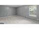 Small bedroom with window and neutral walls and carpet at 120 Bramble Bush Trl, Covington, GA 30014
