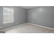 Small bedroom with window and neutral walls and carpet at 120 Bramble Bush Trl, Covington, GA 30014