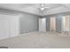 A generous bedroom boasts neutral walls, carpeting, and ample closet space at 120 Bramble Bush Trl, Covington, GA 30014