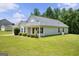 Well-maintained home with a lush lawn, showcasing its side view and inviting landscape at 120 Bramble Bush Trl, Covington, GA 30014