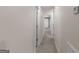 Neutral hallway features carpet and white doors leading to various rooms throughout the house at 120 Bramble Bush Trl, Covington, GA 30014