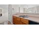 Kitchen area featuring a double sink, wooden cabinets, and a view into the living space at 120 Bramble Bush Trl, Covington, GA 30014