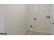 Unfinished laundry room with tile floors and access to water and electrical for appliances at 120 Bramble Bush Trl, Covington, GA 30014